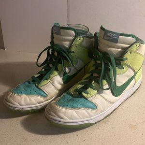 White and green glow in the dark Nike basketball shoes.